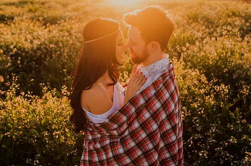 couple man hugging woman surrounded by plants love