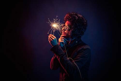 sparkler man in black jacket holding spark man