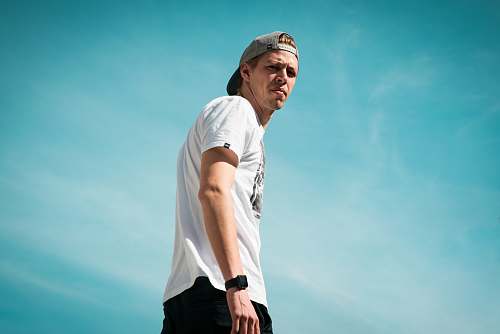 person man in white crew-neck T-shirt blue