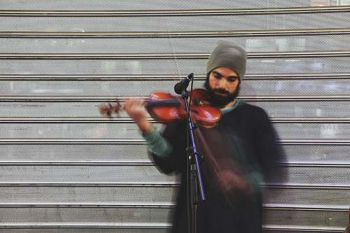person man playing violin during daytime music