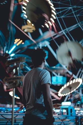 person man standing near amusement park during daytime man