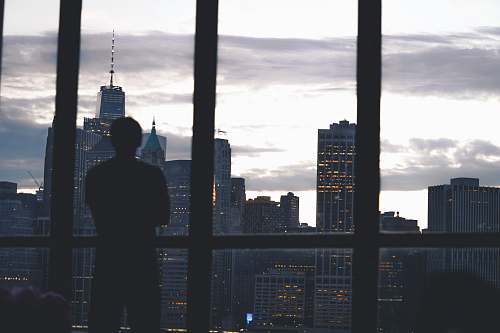 person man standing near window building