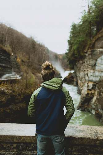 person man standing on bridge over river human