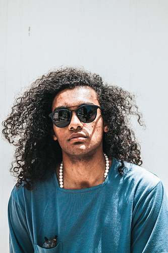 person man wearing blue shirt and black lens sunglasses human