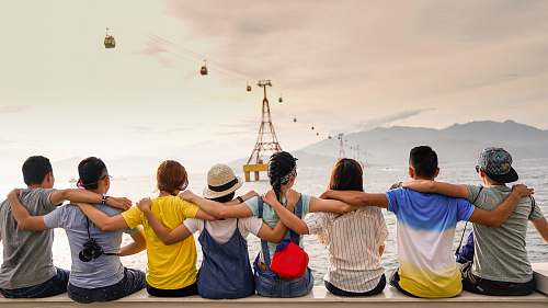 human people holding shoulders sitting on wall person