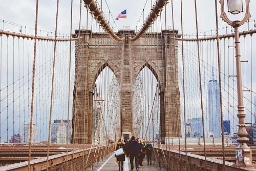 person people walking on Brooklyn Bridge during daytime bridge