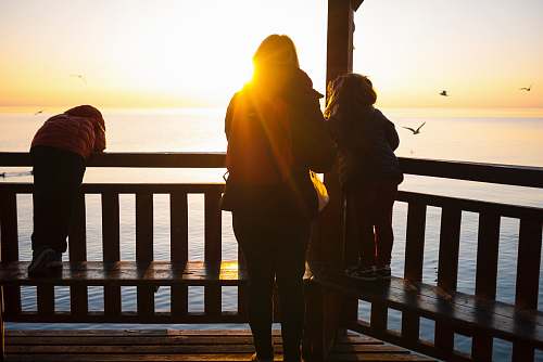 family person near on brown wooden fence children