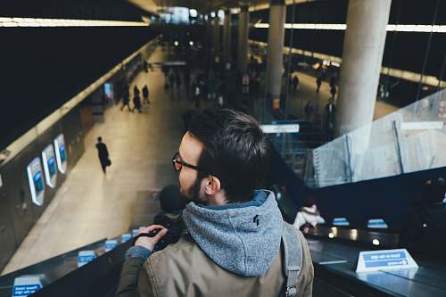 human person standing on escalator in subway station person