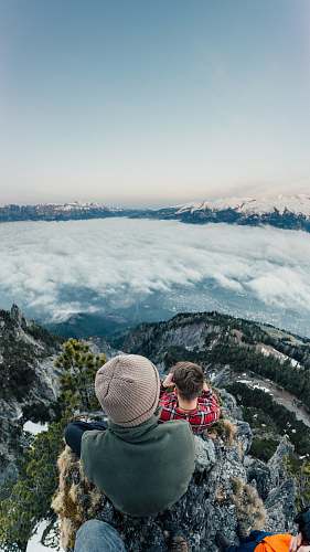 human person standing on mountain peak