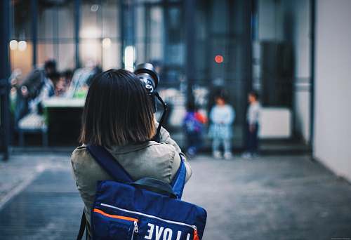 person person taking picture of the building in selective focus photography human