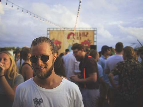 human person wearing white crew-neck shirt beside crowd crowd
