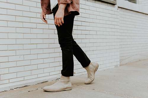 person person wearing white leather chelsea booties and black pants human