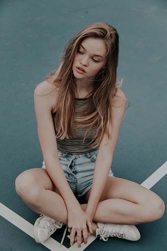 person photo of blonde-haired woman sitting on floor human
