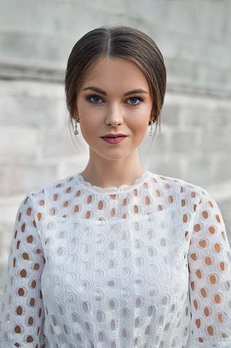 person shallow focus photo of woman standing near wall human