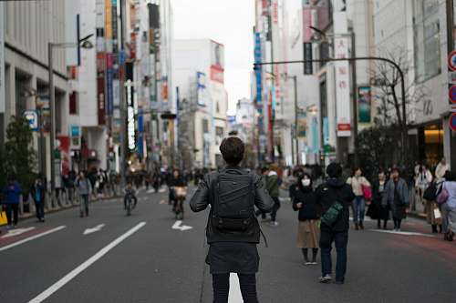 person shallow focus photography of person carrying backpack human