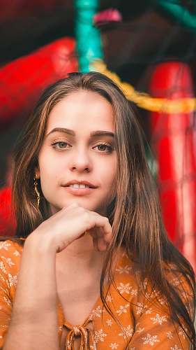 woman shallow focus photography of woman in brown floral top portrait