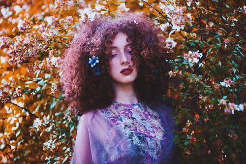 woman shallow focus photography of woman leaning on plant person