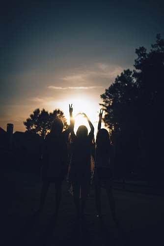 person silhouette of three women during daytime girls