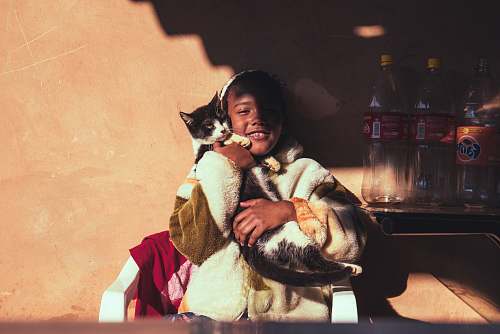 campinas smiling girl hugging cat leaning on wall brazil