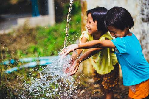 person two girl playing water kid