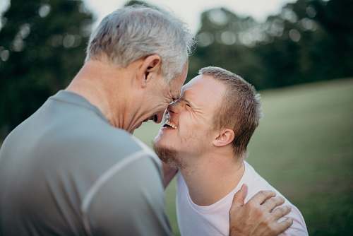 person two man talking to each other on grass field human