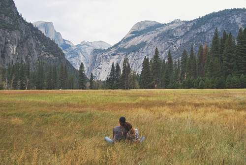 couple two person sitting on grass field field