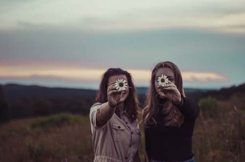 person two women holding flowers human
