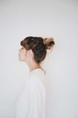 human woman beside white wall person