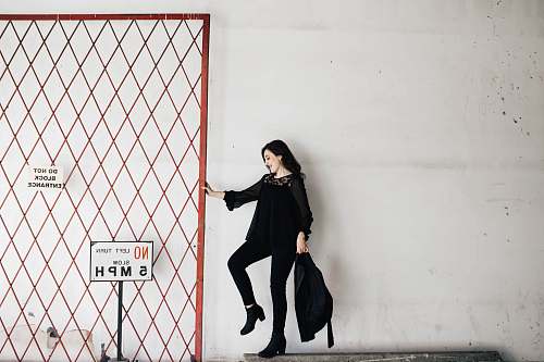 woman woman carrying black bag white wall