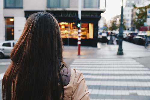 person woman crossing street road