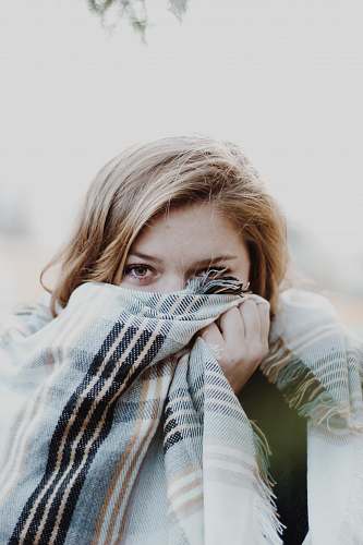 human woman hiding her face with scarf woman