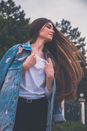 woman woman holding her white shirt flipping hair girl