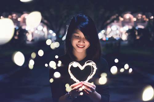 woman woman holding lit heart love