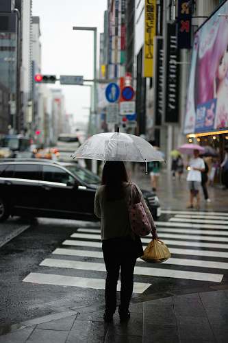 human woman holding umbrella standing on pedestal lane umbrella