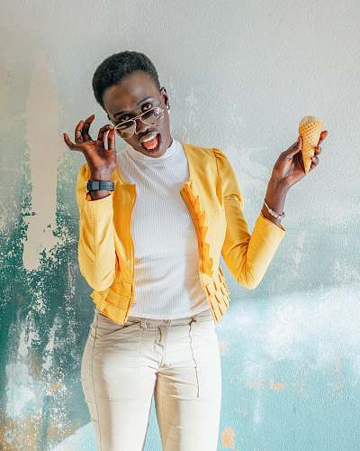 human woman in yellow jacket holding ice cream person