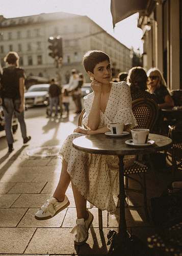 person woman leaning on table in cafe human