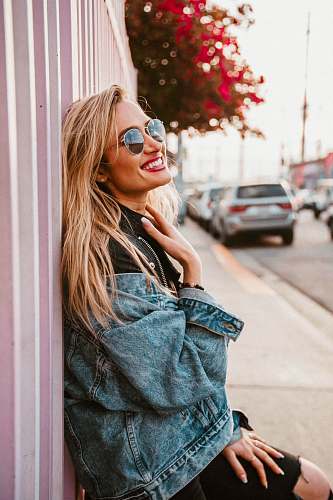 person woman lying on pink wall during daytime car