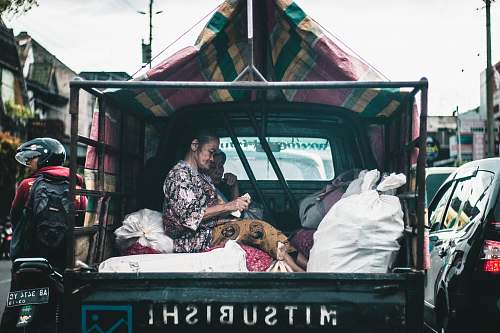 person woman seating on drop side truck truck