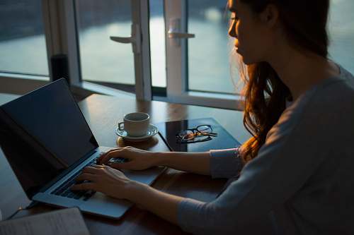 laptop woman sitting beside table using laptop computer