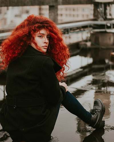 person woman sitting on brown surface human
