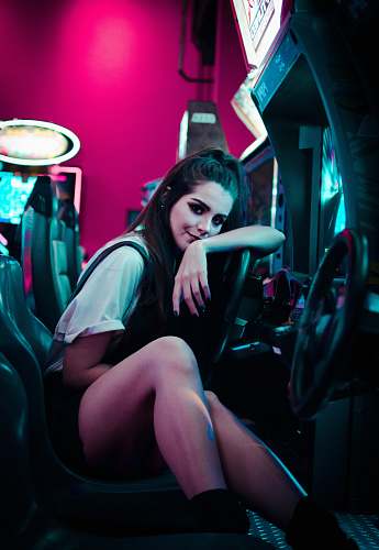 person woman sitting on car arcade machine human