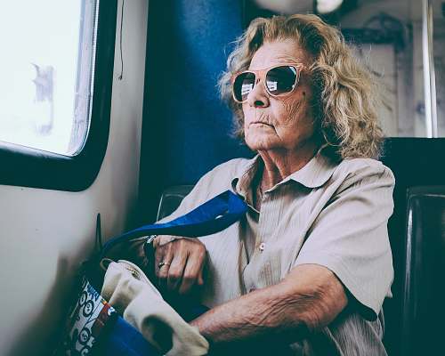 person woman sitting on chair in front of window human