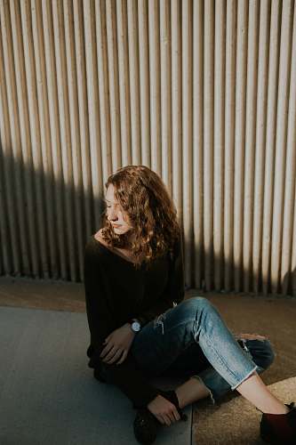 person woman sitting on ground human