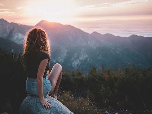person woman sitting on rock human