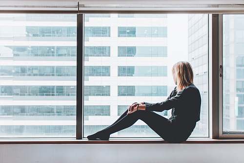 woman woman sitting on window window