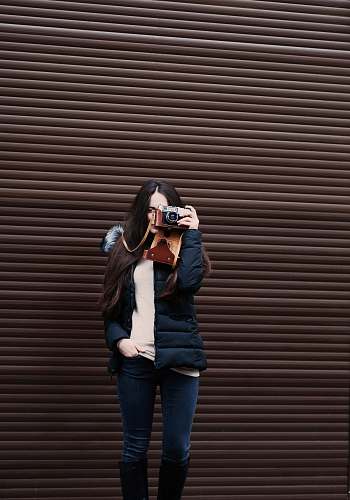 person woman standing holding camera taking photo human