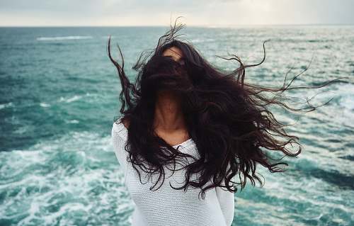 person woman standing near body of water during daytime woman