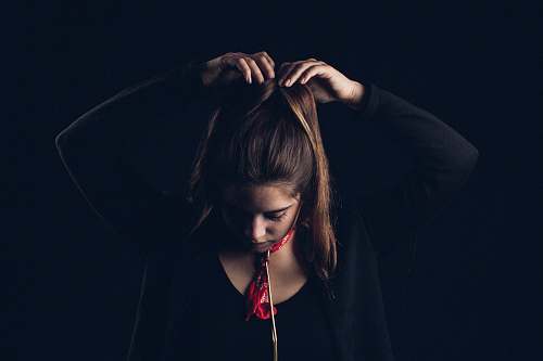 human woman tying hair with both hands person