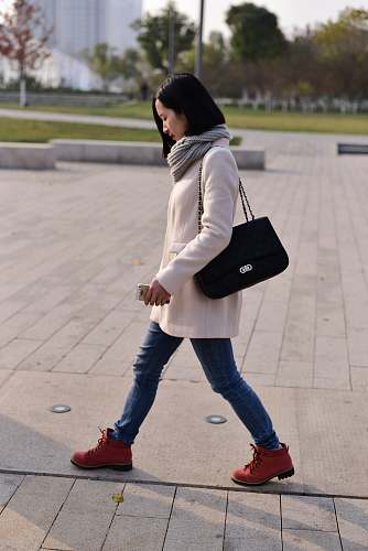 person woman walking while holding smartphone walk