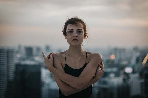 person woman wearing black spaghetti strap sleeveless top human